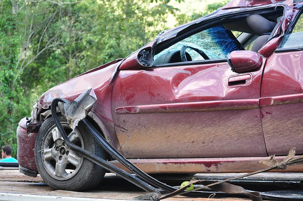 Crashed red car facing left 