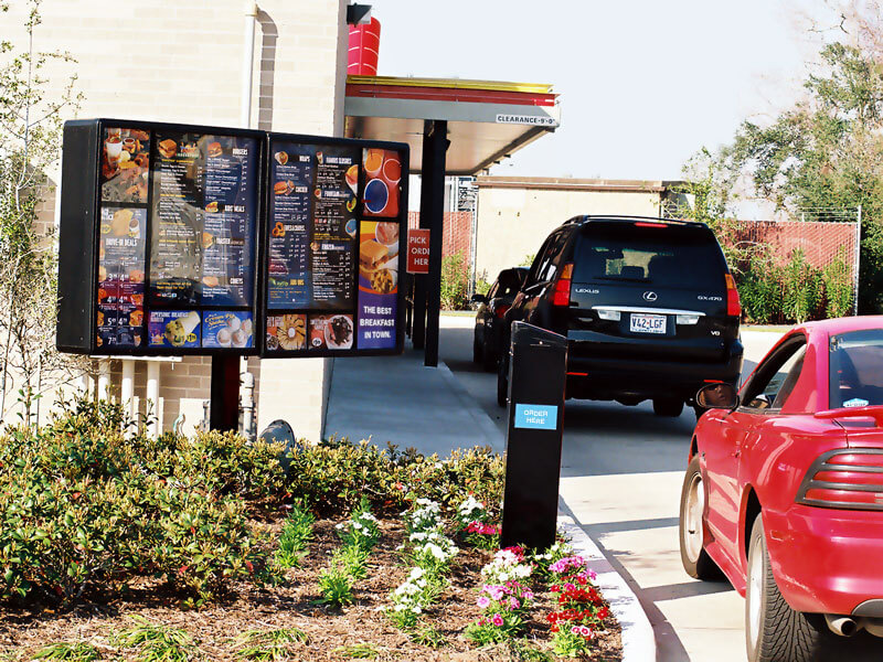 Cars in fast food drive thru line