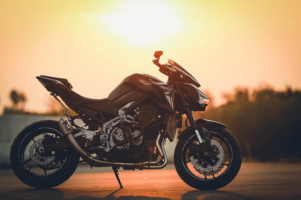 Parked motorcycle in front of sunset
