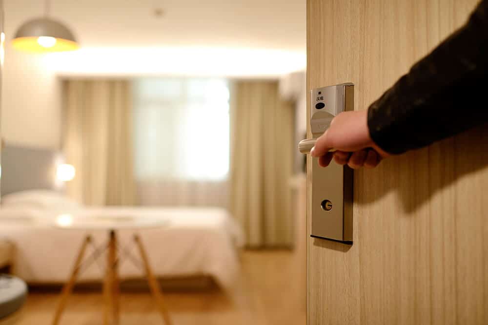 Person opening hotel door